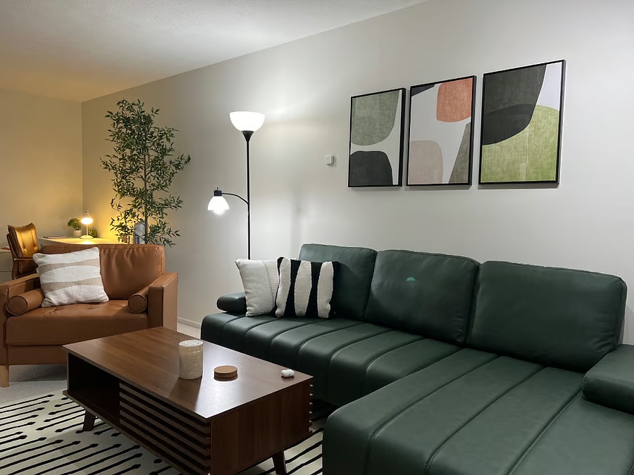 Living room with green leather seating